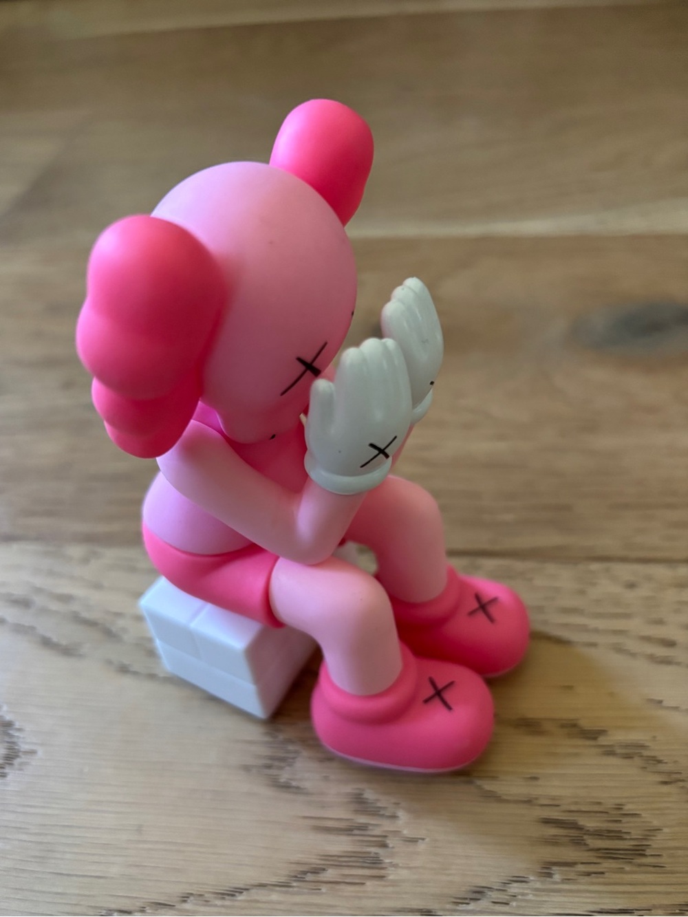 Kaws pink sitting figurine